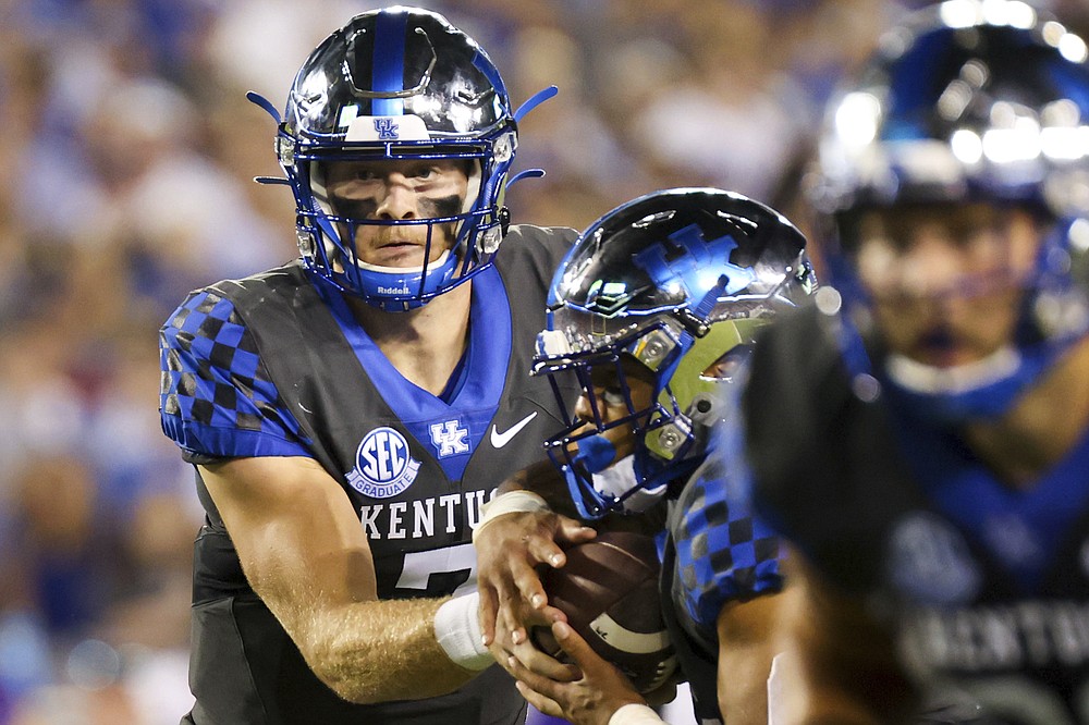 Kentucky quarterback Will Levis (7) hands the ball off during the first half of the team's NCAA college football game against LSU in Lexington, Ky., Saturday, Oct. 9, 2021. (AP Photo/Michael Clubb)