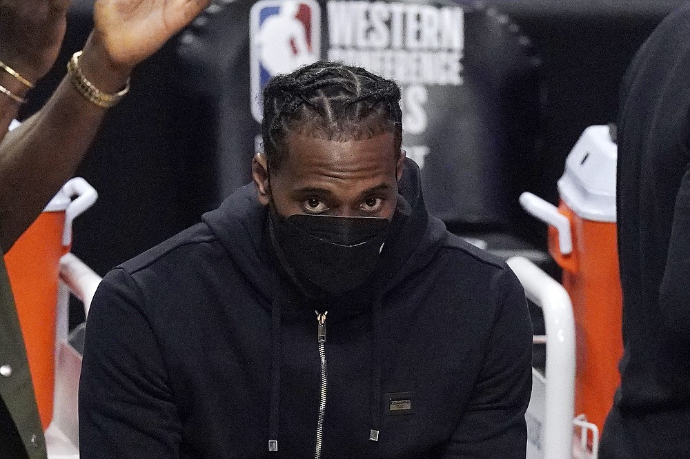 FILE - Los Angeles Clippers forward Kawhi Leonard sits on the bench during the first half in Game 6 of the NBA basketball Western Conference Finals against the Phoenix Suns in Los Angeles, in this Wednesday, June 30, 2021, file photo. The biggest question hanging over the Clippers is when Leonard will return. Will he work his way back from knee surgery to repair a partially torn ACL before the end of the regular season? Or for the playoffs? Or remain out until next season?
Even he isn't sure. (AP Photo/Mark J. Terrill, File)