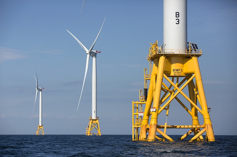 FILE - In this Aug. 15, 2016 file photo, three of Deepwater Wind's five turbines stand in the water off Block Island, R.I, the nation's first offshore wind farm.  Interior Secretary Deb Haaland says the Biden administration will hold lease sales for up to seven offshore wind farms on the East and West coasts and in the Gulf of Mexico in the next four years. The projects are part of the administration's plan to deploy 30 gigawatts of offshore wind energy by 2030,  generating enough electricity to power more than 10 million homes.  (AP Photo/Michael Dwyer, File)