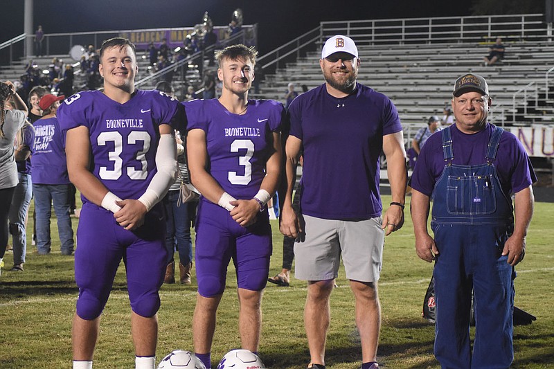 The Ray family has had a huge impact on Booneville Bearcat football for three generations, starting with Bruce Ray, far right. Allen Ray, second from right, is Bruce's son and is the school's all-time leading rusher with more than 4,200 career rushing yards. Allen's sons Rylen (33) and Randon (3) are powering this year's team and Randon is nearing breaking his father's career rushing record at the halfway point of his senior season. Another son, Carson, helped the Bearcats claim the state title in 2018.