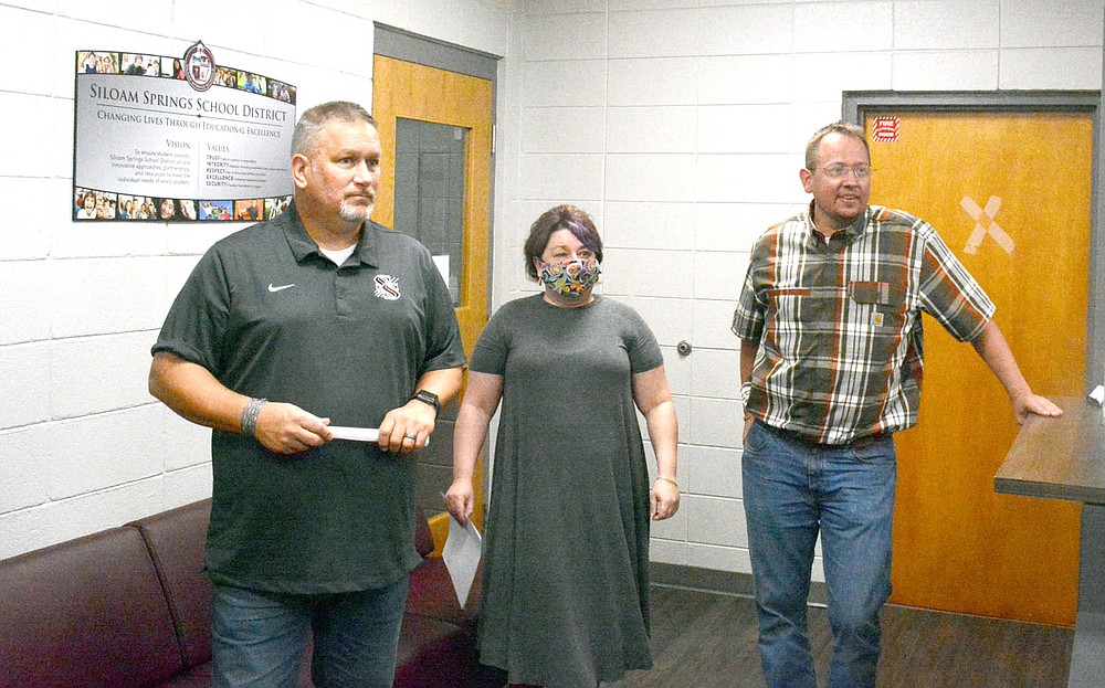 Marc Hayot/Siloam Sunday CFO Terri Raskiewicz (center), along with school board members Travis Jackson (left) and Grant Loyd, listen to a presentation on Thursday from Northside Elementary principal Jerrie Price. Members of the school board visited Northside to have lunch and toured the campus.