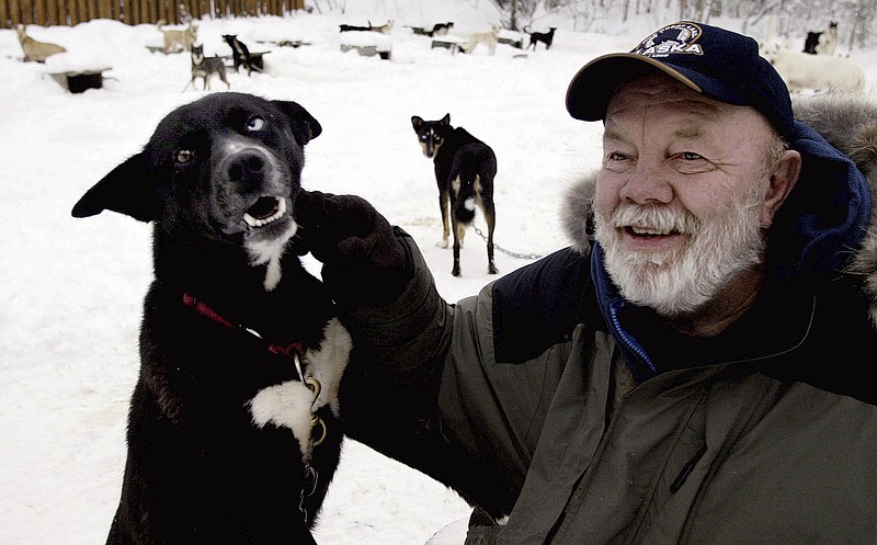 Author Gary Paulsen sits with his favorite Alaskan husky, Flax, at his Willow, Alaska, home on Feb. 10, 2005. Paulsen died Wednesday, Oct. 13, 2021 at age 82. (AP Photo/Al Grillo, File)