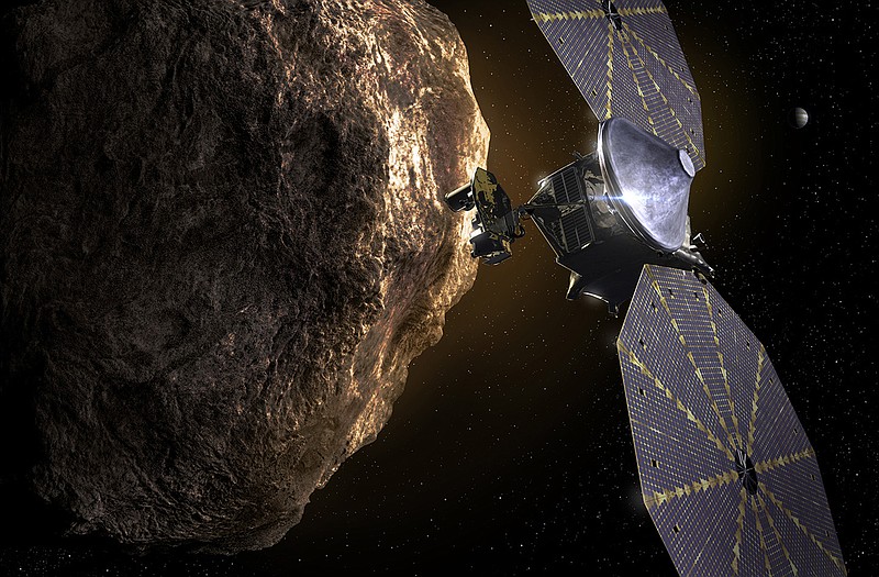This image provided by the Southwest Research Institute depicts the Lucy spacecraft approaching an asteroid. It will be first space mission to explore a diverse population of small bodies known as the Jupiter Trojan asteroids. (SwRI via AP)