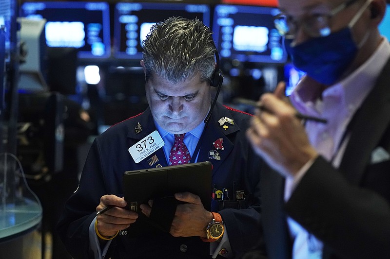 Trader John Panin, left, works on the floor of the New York Stock Exchange, Thursday, Oct. 14, 2021.Stocks are moving broadly higher in early trading on Wall Street as the market builds momentum a day after breaking a three-day losing streak. (AP Photo/Richard Drew)