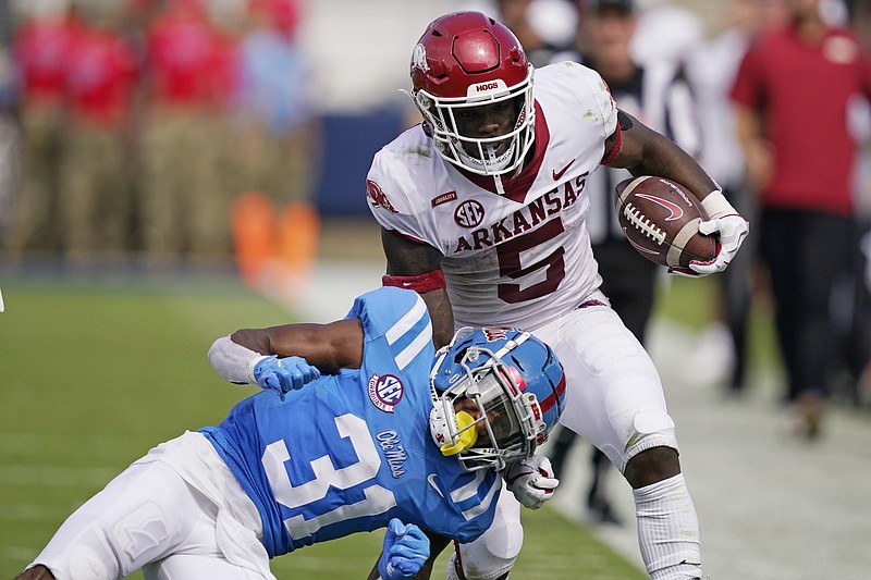 Arkansas running back Raheim Sanders (5) is knocked out of bounds by Mississippi defensive back Jaylon Jones (31) during the second half of an NCAA college football game, Saturday, Oct. 9, 2021, in Oxford, Miss. Mississippi won 52-51. (AP Photo/Rogelio V. Solis)