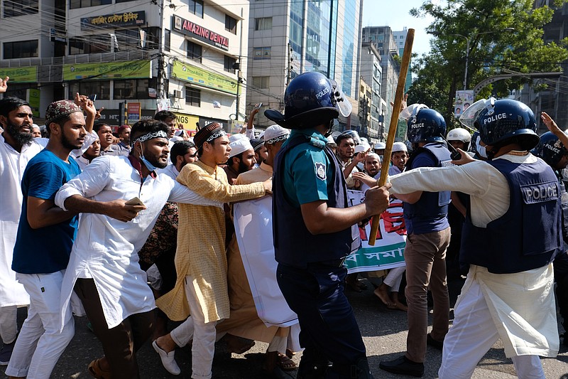 Police clash with Muslim devotees during a protest  over an alleged insult to Islam, outside the country&#x2019; main Baitul Mukarram Mosque in Dhaka, Bangladesh, Friday, Oct. 15, 2021. Friday&#x2019;s chaos in Dhaka followed reported incidents of vandalism of Hindu temples in parts of the Muslim-majority Bangladesh after photographs of a copy of the Holy book Quran at the feet of of a Hindu Goddess went viral on social media in a temple at Cumilla district in eastern Bangladesh. (AP Photo/Mahmud Hossain Opu, File)
