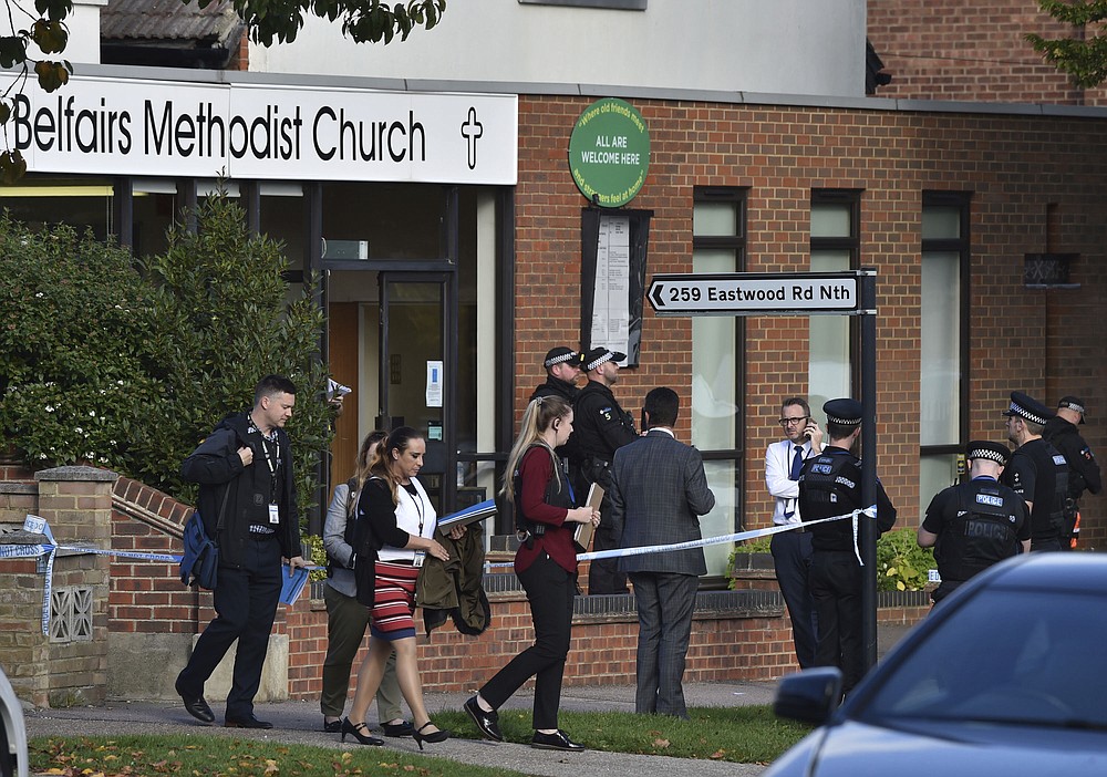 People leave the Belfairs Methodist Church in Eastwood Road North, where Conservative MP Sir David Amess has reportedly been stabbed several times at a constituency surgery, in Leigh-on-Sea, Essex, England, Friday, Oct. 15, 2021. British police say a man has been arrested after a reported stabbing in eastern England. News outlets say the victim is Conservative lawmaker David Amess. The Essex Police force said officers were called to reports of a stabbing in Leigh-on-Sea just after noon Friday. It said “a man was arrested shortly after & we’re not looking for anyone else.” (Nick Ansell/PA via AP)
