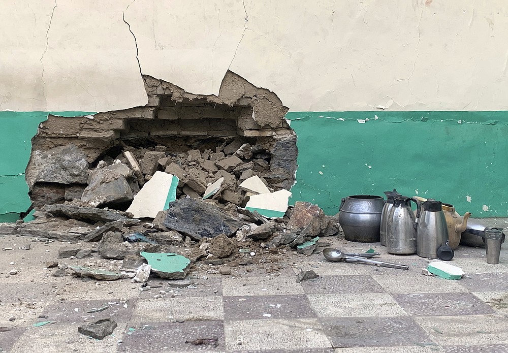 Damaged wall of a mosque is seen following a suicide bombers attack in the city of Kandahar, southwest Afghanistan, Friday, Oct. 15, 2021. Suicide bombers attacked a Shiite mosque in southern Afghanistan that was packed with worshippers attending Friday prayers, killing several people and wounding others, according to a hospital official and a witness. (AP Photo/Sidiqullah Khan)