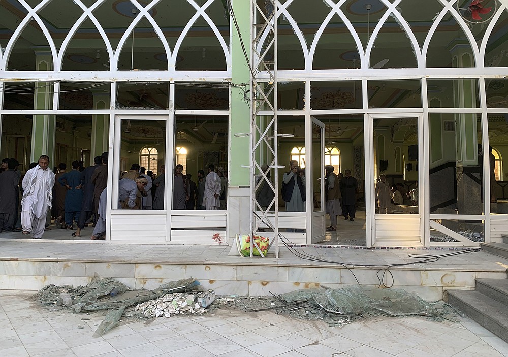 People view the damage inside of a mosque following a suicide bombers attack in the city of Kandahar, southwest Afghanistan, Friday, Oct. 15, 2021. Suicide bombers attacked a Shiite mosque in southern Afghanistan that was packed with worshippers attending Friday prayers, killing several people and wounding others, according to a hospital official and a witness. (AP Photo/Sidiqullah Khan)
