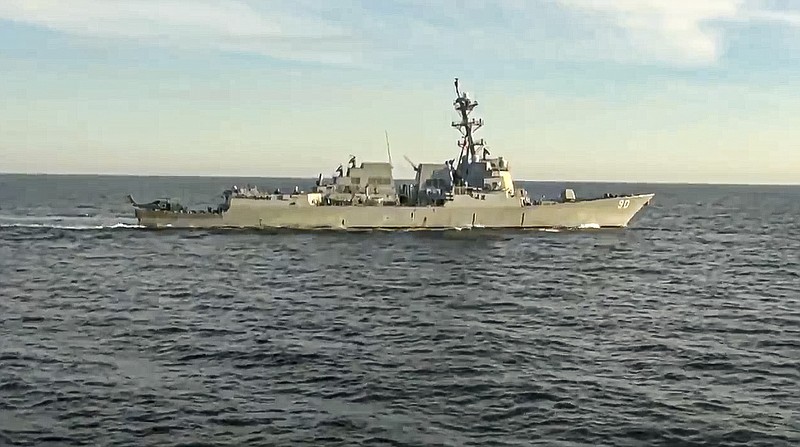 In this handout photo taken from video released by Russian Defense Ministry Press Service, the U.S. destroyer USS Chafee is seen from Russian navy's Admiral Tributs destroyer near Russian territorial waters in the Sea of Japan on Friday, Oct. 15, 2021. Russia's Defense Ministry says a Russian warship has prevented a U.S. Navy destroyer from what it described as an attempt to intrude into Russian territorial waters in the Sea of Japan. The ministry charged that the Russian navy's Admiral Tributs destroyer closely approached the U.S. destroyer USS Chafee to force it out of the area Friday near Russian waters that was declared off limits to shipping due to a Russian artillery drills. (Russian Defense Ministry Press Service via AP)