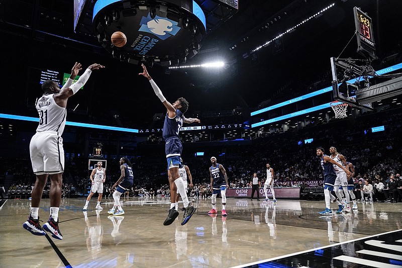 Brooklyn Nets' Paul Millsap (31) shoots a 3-pointer over Minnesota Timberwolves' Jaden McDaniels (3) during the second half of a preseason NBA basketball game Thursday, Oct. 14, 2021, in New York. (AP Photo/Frank Franklin II)