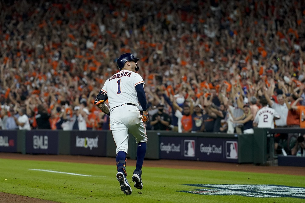 Houston Astros' Carlos Correa celebrates a home run against the Boston Red Sox during the seventh inning in Game 1 of baseball's American League Championship Series Friday, Oct. 15, 2021, in Houston. (AP Photo/Tony Gutierrez)