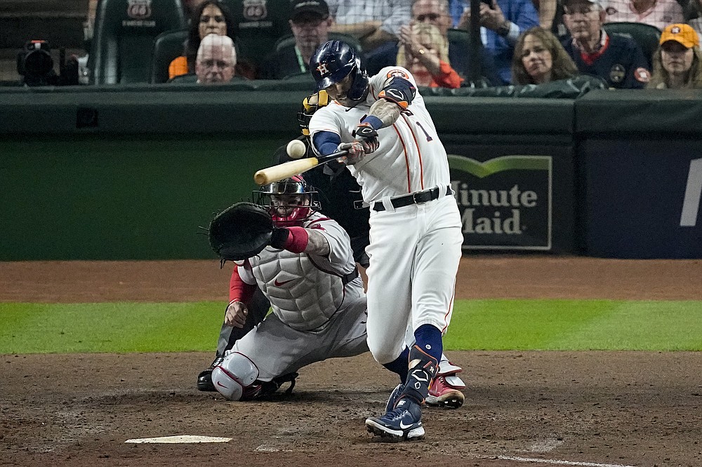 Houston Astros' Carlos Correa hits single against the Boston Red Sox during the third inning in Game 1 of baseball's American League Championship Series Friday, Oct. 15, 2021, in Houston. (AP Photo/Sue Ogrocki)