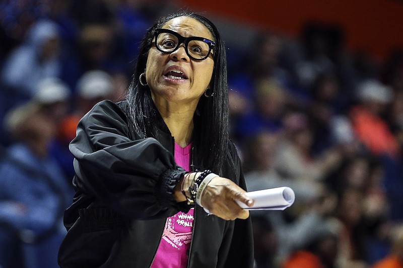 FILE - In this Feb. 27, 2020, file photo, South Carolina head coach Dawn Staley reacts to an official's call during the second half of an NCAA college basketball game against Florida in Gainesville, Fla. Dawn Staley and South Carolina have agreed to a new, seven-year contract that will pay her $2.9 million this season and grow to $3.5 million in the final season.  The school's Board of Trustees approved the deal worth $22.4 million on Friday, Oct. 15, 2021, to keep the national championship coach with the Gamecocks through the 2027-28 season. (AP Photo/Gary McCullough, File)