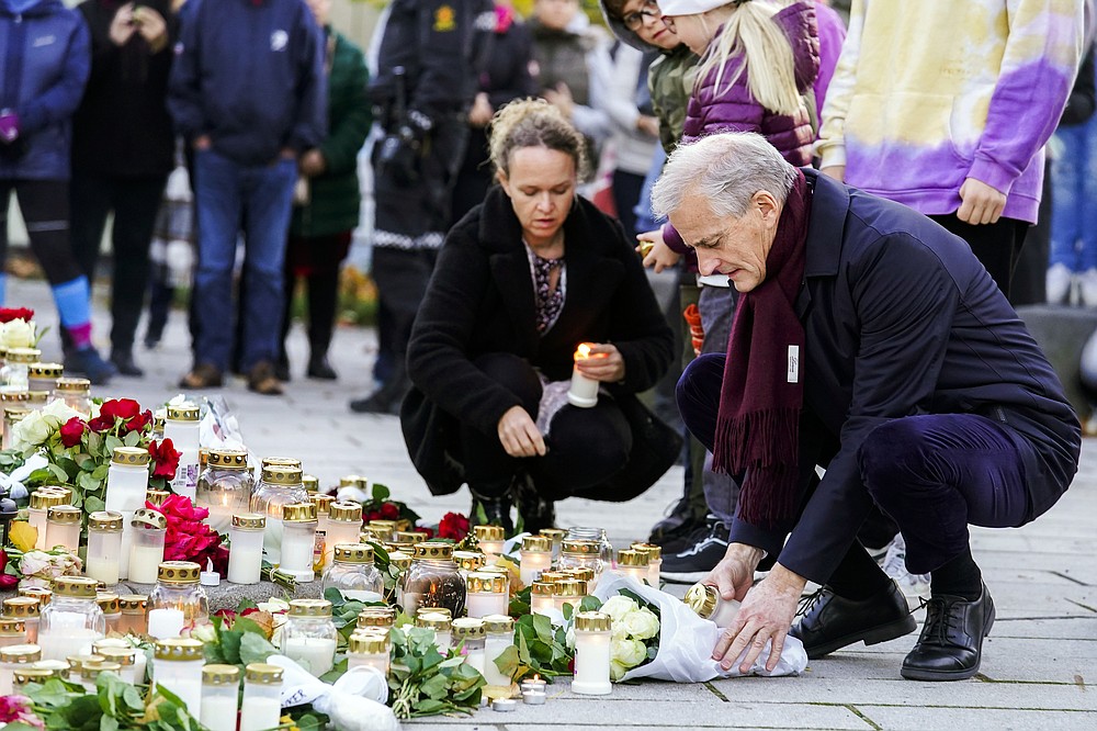 Norway's Prime Minister Jonas Gahr Støre lays flowers and lights candles during his visit to Kongsberg, Norway, Friday, Oct. 15, 2021. The suspect in a bow-and-arrow attack that killed five people and wounded three in a small Norwegian town is facing a custody hearing Friday. He won’t appear in court because he has has confessed to the killings and has agreed to being held in custody. (Terje Bendiksby/NTB via AP)