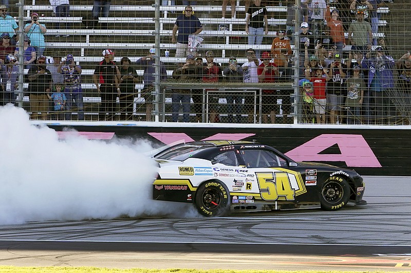 John H. Nemechek (54) celebrates after winning a NASCAR Xfinity Series auto race at Texas Motor Speedway Saturday, Oct. 16, 2021, in Fort Worth, Texas. (AP Photo/Larry Papke)