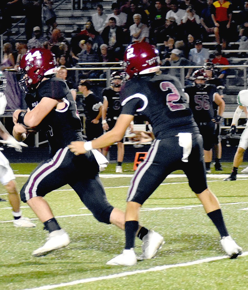 MARK HUMPHREY  ENTERPRISE-LEADER/Lincoln sophomore running back Nick Martinez takes a handoff from classmate, quarterback Drew Moore. The Wolves came up five points short, losing 28-23 on the road at Mansfield Friday.