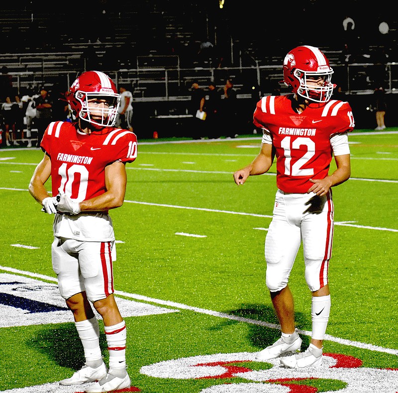 MARK HUMPHREY  ENTERPRISE-LEADER/Farmington senior receiver Justin Logue (left) and sophomore quarterback Cameron Vanzant connected on six passes for 168 yards during the Cardinals' 39-0 road win at Clarksville Friday.