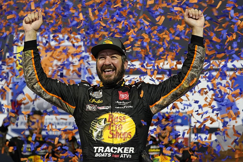 FILE - In this Sept. 11, 2021, file photo, Martin Truex Jr., celebrates winning the NASCAR Cup series auto race in Richmond, Va. Truex is in third place in the NASCAR playoff standings heading into Sunday's race at Fort Worth, Texas.  (AP Photo/Steve Helber, File)