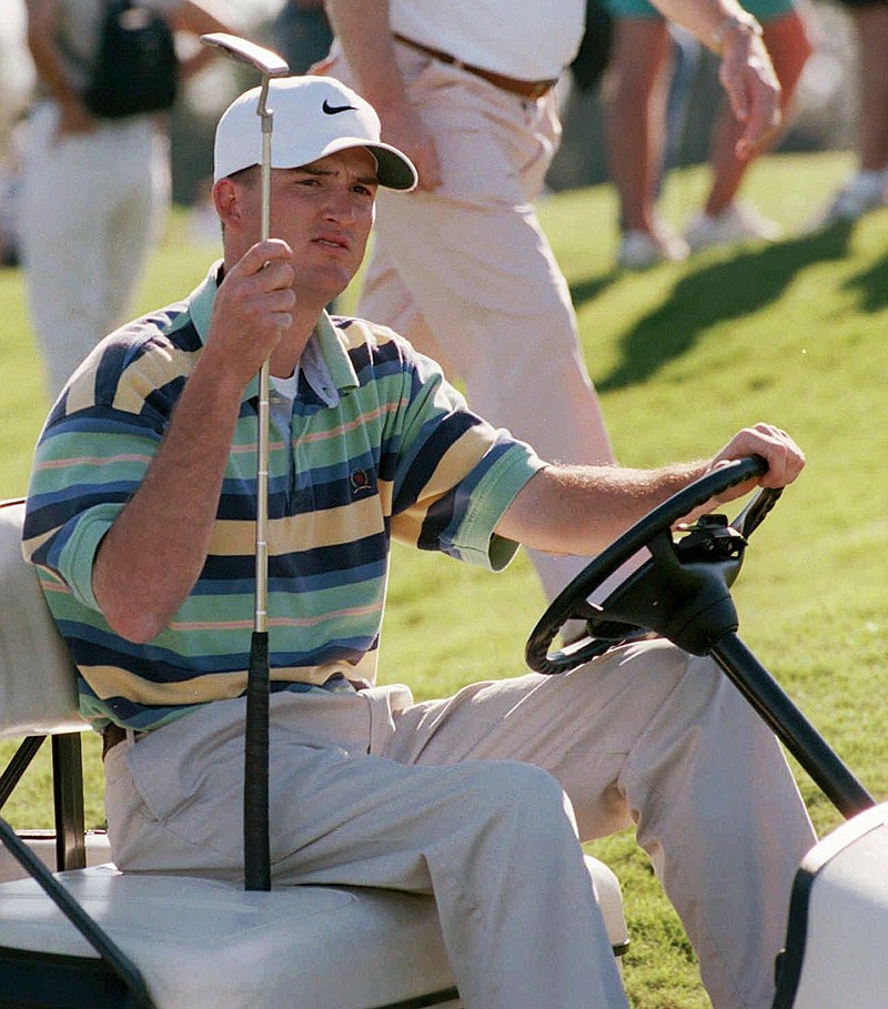 FILE - In this Jan. 11, 1998, file photo, Casey Martin holds his putter after he won the Nike Lakeland Classic at Grasslands Golf and Country Club in Lakeland, Fla. Martin, the Oregon golf coach who successfully sued the PGA Tour for the right to use a cart because of a rare circulatory disease, had his right leg amputated in what he told Golf Digest was always going to be &#x201c;my destiny.&#x201d; The magazine, which has been in touch with Martin over the last few weeks, reported on its website that he had surgery Friday, Oct. 14, 2021, and was recovering at the Mayo Clinic in Rochester, Minn.  (David Mills/The Ledger via AP)