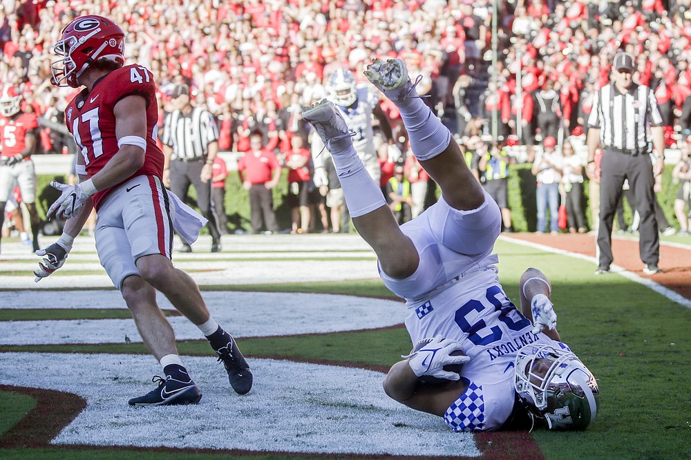 Kentucky tight end Justin Rigg (83) catches a pass for a touchdown against Georgia defensive back Dan Jackson (47) during the first half of an NCAA college football game Saturday, Oct. 16, 2021 in Athens, Ga. (AP Photo/Butch Dill)