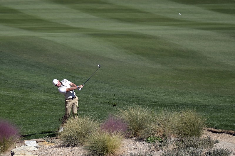Rory McIlroy, of Northern Ireland, hits on the 17th hole during first round of the CJ Cup golf tournament Thursday, Oct. 14, 2021, in Las Vegas. (AP Photo/David Becker)