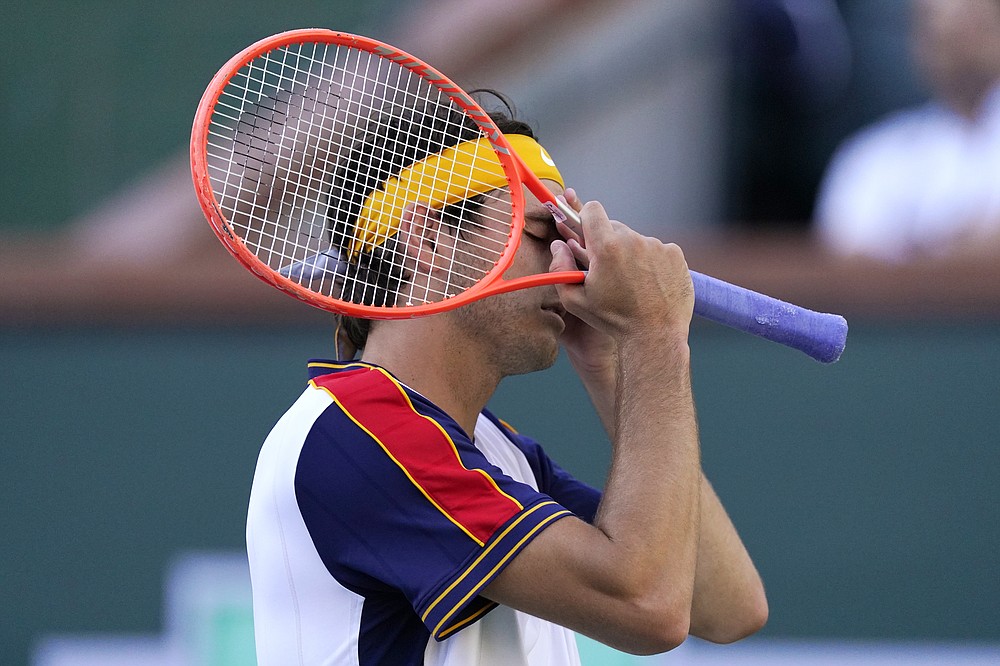 Taylor Fritz, of the United States, reacts after losing a point to Nikoloz Basilashvili, of Georgia, in a semifinal at the BNP Paribas Open tennis tournament Saturday, Oct. 16, 2021, in Indian Wells, Calif. (AP Photo/Mark J. Terrill)