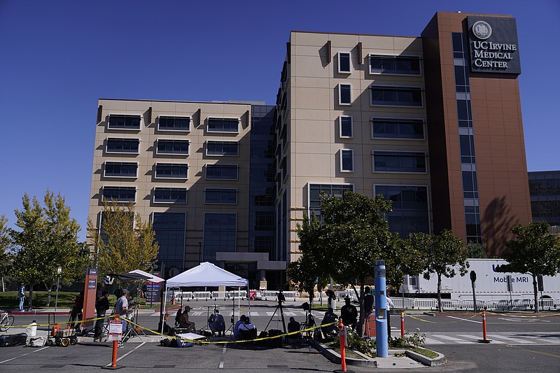 Members of the media stand outside the University of California Irvine Medical Center in Orange, Calif., Saturday, Oct. 16, 2021. A spokesman says former president Bill Clinton will spend one more night at the hospital where he is recovering from an infection. (AP Photo/Damian Dovarganes)