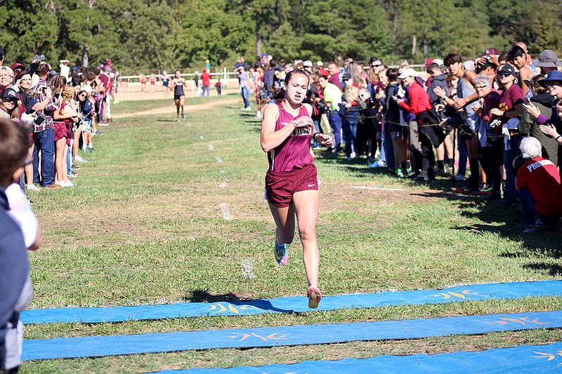 Lake Hamilton's Olivia Pielemeier crosses the finish line to win the Lake Hamilton Invitational at Oaklawn Saturday. - Photo by James Leigh of The Sentinel-Record