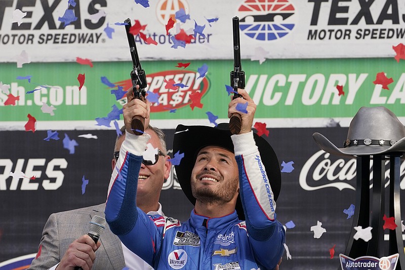 Kyle Larson (5) celebrates after winning a NASCAR Cup Series auto race at Texas Motor Speedway Sunday, Oct. 17, 2021, in Fort Worth, Texas. (AP Photo/Larry Papke)