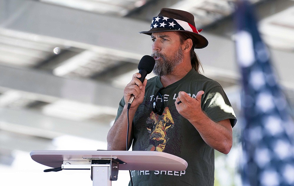 FILE - In this Nov. 9, 2020, file photo, Alan Hostetter speaks during a pro-Trump election integrity rally he organized at the Orange County Registrar of Voters offices in Santa Ana, Calif. Hostetter is one of at least five people charged in the riot at the U.S. Capitol on Jan. 6, 2021, who have chosen to defend themselves in court, brushing aside federal judges’ repeated warnings about the risks of trying to navigate their high-stakes cases without an attorney. (Paul Bersebach/The Orange County Register via AP)