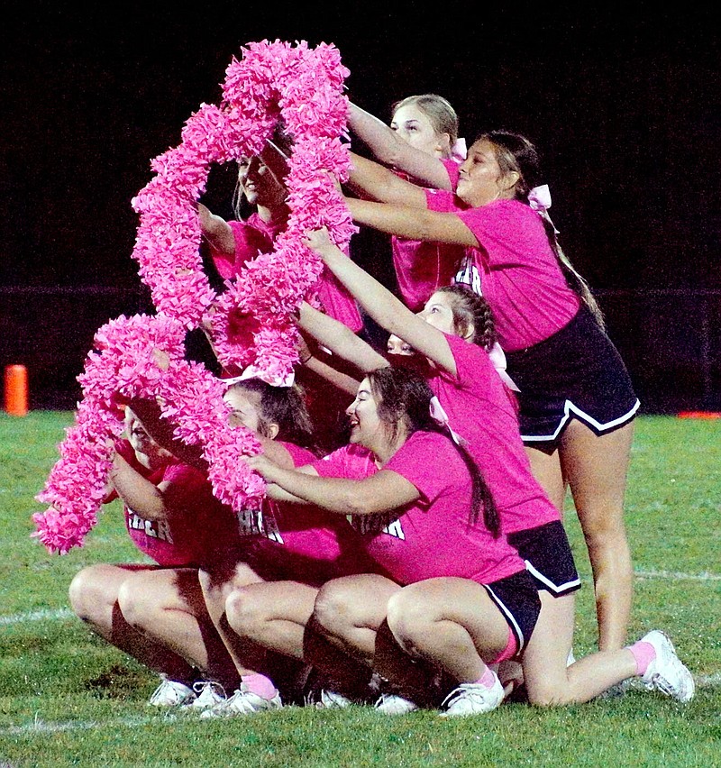 Westside Eagle Observer/RANDY MOLL
Gentry High School cheerleaders used their pom-poms to form a pink breast cancer awareness symbol during halftime at Pioneer Stadium on Friday.