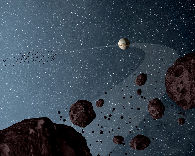 The Jovian Trojans lap the sun in the same orbit as Jupiter in this artistic illustration of information collected by NASA's Wide-field Infrared Explorer, or WISE.
Data show that the asteroids are uniformly dark with a hint of burgundy color, and have matte surfaces that reflect little sunlight. 
(Photo courtesy of NASA/JPL-Caltech)