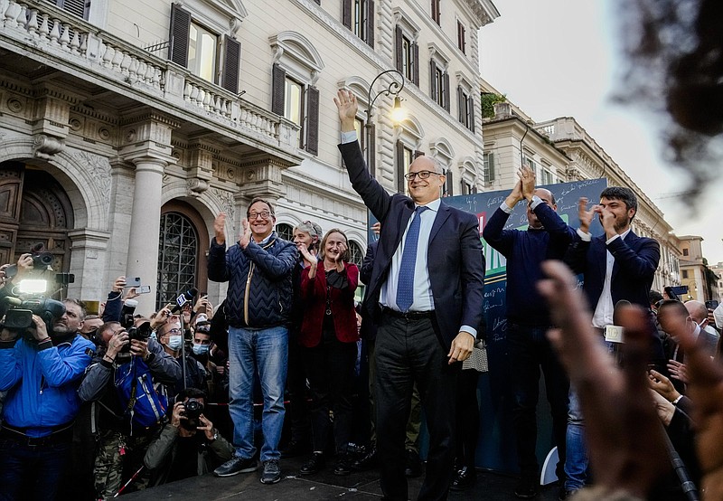 Center-left mayoral candidate Roberto Gualtieri stands in a square in Rome, Monday, Oct. 18, 2021, where he is claiming victory after the first projections. The top vote-getters in the first round of balloting two weeks earlier, Enrico Michetti, a novice politician backed by a far-right leader, and Roberto Gualtieri, a Democrat and former finance minister, competed in the runoff Sunday and Monday. (AP Photo/Gregorio Borgia)