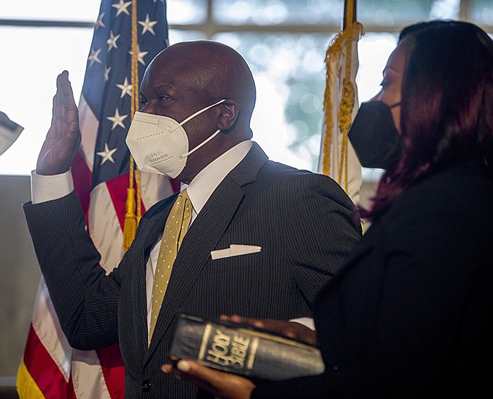 Virgil Miller takes his oath of office as his wife, Stephanie, holds his mother's bible during a ceremony at City Hall on Monday, Oct. 18, 2021. Miller was appointed to the Ward 1 Little Rock Board of Directors for the remainder of the current term of the late Erma Hendrix.

(Arkansas Democrat-Gazette/Stephen Swofford)