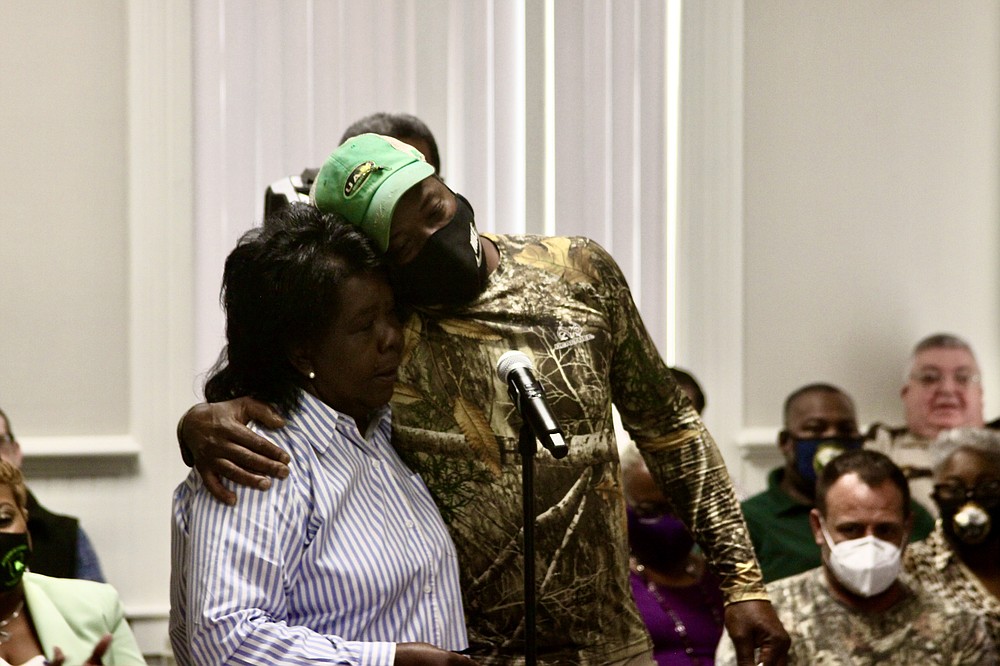 Justice of the Peace Brenda Gaddy (left) consoles widower Kevin Burris Sr. whose wife Marie died from covid-19 in July. (Pine Bluff Commercial/Eplunus Colvin)