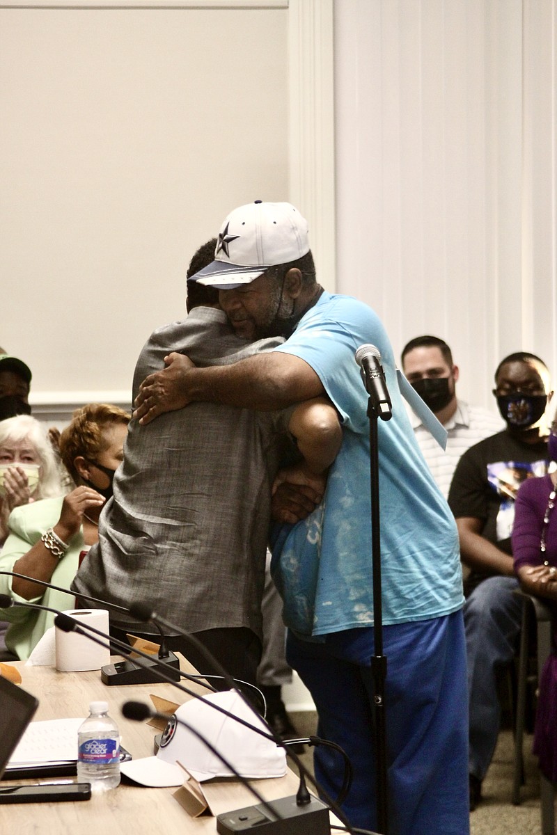 Justice of the Peace Alfred Carroll (left) hugs Rev. Ricky Mays who just buried his wife, Sharon, a few weeks ago. (Pine Bluff Commercial/Eplunus Colvin)