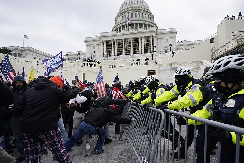 FILE - In this Jan. 6, 2021 file photo, Trump supporters try to break through a police barrier at the Capitol in Washington. A House committee tasked with investigating the Jan. 6 Capitol insurrection is moving swiftly to hold at least one of Donald Trump&#x2019;s allies, former White House aide Steve Bannon, in contempt. That's happening as the former president is pushing back on the probe in a new lawsuit. (AP Photo/Julio Cortez)