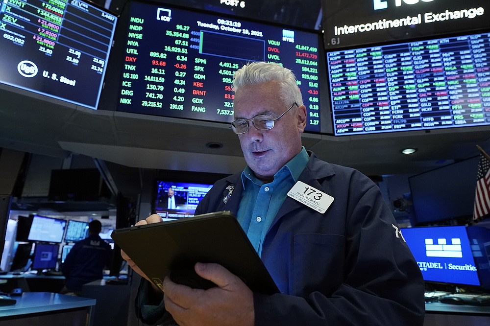 Trader Frank O'Connell works on the floor of the New York Stock Exchange, Tuesday, Oct. 19, 2021. Stocks are moving modestly higher on Wall Street in early trading Tuesday as corporate earnings reporting gets into full swing. (AP Photo/Richard Drew)