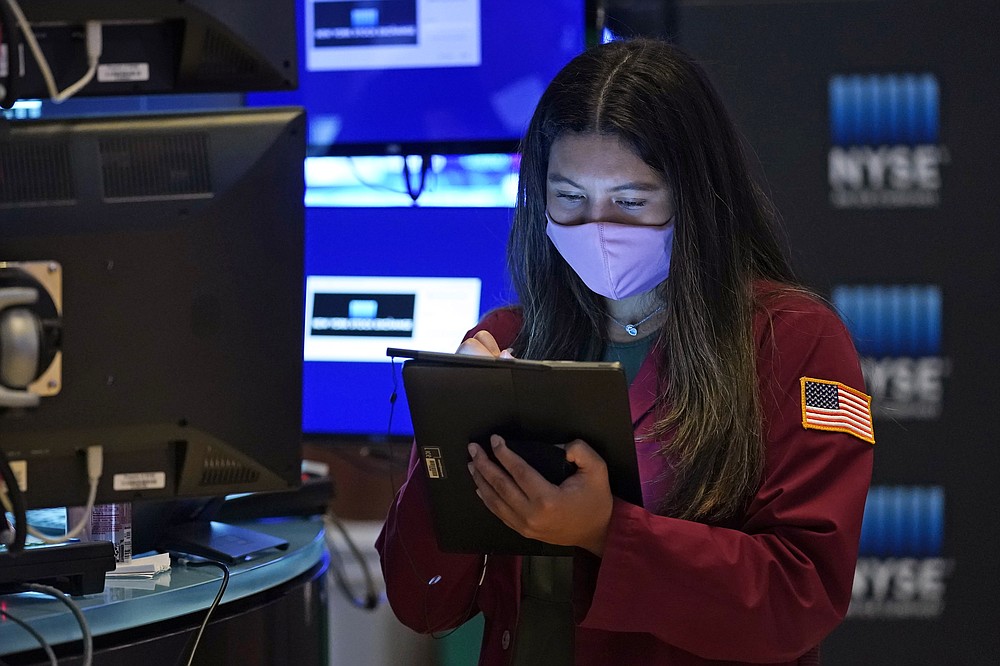 Trader Ashley Lara works on the floor of the New York Stock Exchange, Tuesday, Oct. 19, 2021. Stocks are moving modestly higher on Wall Street in early trading Tuesday as corporate earnings reporting gets into full swing. (AP Photo/Richard Drew)