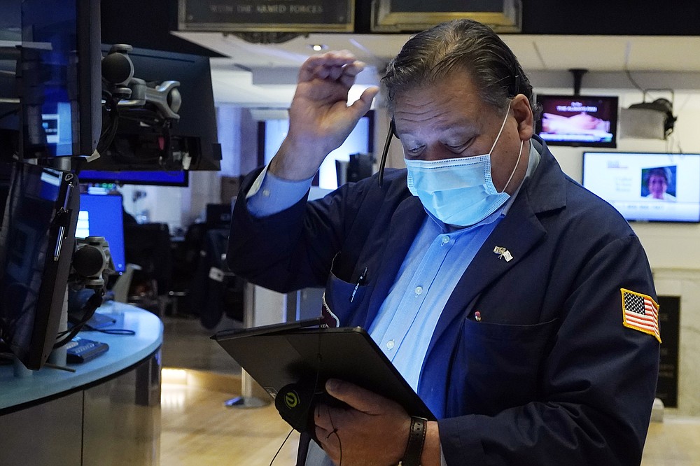 Trader John Santiago works on the floor of the New York Stock Exchange, Tuesday, Oct. 19, 2021. Stocks are moving modestly higher on Wall Street in early trading Tuesday as corporate earnings reporting gets into full swing. (AP Photo/Richard Drew)