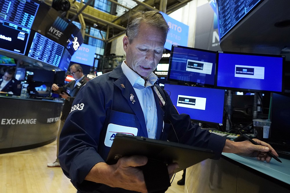Trader Robert Charmak works on the floor of the New York Stock Exchange, Tuesday, Oct. 19, 2021. Stocks are moving modestly higher on Wall Street in early trading Tuesday as corporate earnings reporting gets into full swing. (AP Photo/Richard Drew)
