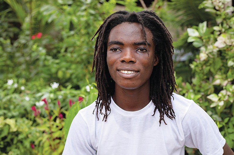 Tyrone Iras Marhguy, 17, pose for a photograph at his home in Accra, Ghana, Sunday, Oct. 10, 2021. An official at the academically elite Achimota School in Ghana told the teen he would have to cut his dreadlocks before enrolling. For Marhguy, who is a Rastafarian, cutting his dreadlocks is non-negotiable so he and his family asked the courts to intervene. (AP Photo/Nipah Dennis)