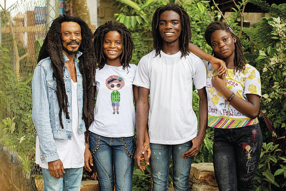 From left, Tereo Awareness Marhguy, Nikita Hive Marhguy, 17, Tyrone Iras Marhguy, 17, and Amrita Sheeba Marhguy poses for a photograph at their home in Accra, Ghana, Sunday, Oct. 10, 2021. An official at the academically elite Achimota School in Ghana told Tyrone he would have to cut his dreadlocks before enrolling. For Marhguy, who is a Rastafarian, cutting his dreadlocks is non-negotiable so he and his family asked the courts to intervene. (AP Photo/Nipah Dennis)