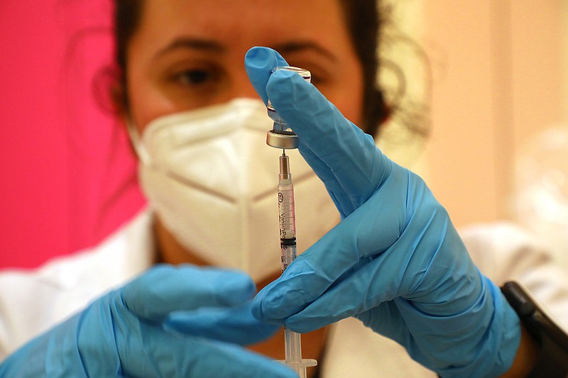 FILE &#x2014; A medical worker prepares a COVID-19 vaccine booster in San Rafael, Calf., on Sept. 29, 2021. Vacccinations typically consist of two or more doses of the same vaccine, but the Food and Drug Administration is expected to authorize a mix-and-match strategy for COVID-19. (Jim Wilson/The New York Times)