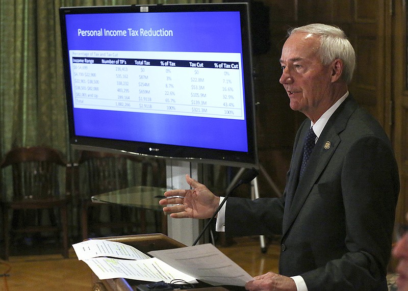 Gov. Asa Hutchinson shows off his proposed state income tax reduction plan during the weekly media briefing on Tuesday, Oct. 19, 2021, at the state Capitol in Little Rock. 
More photos at www.arkansasonline.com/1020gov/
(Arkansas Democrat-Gazette/Thomas Metthe)