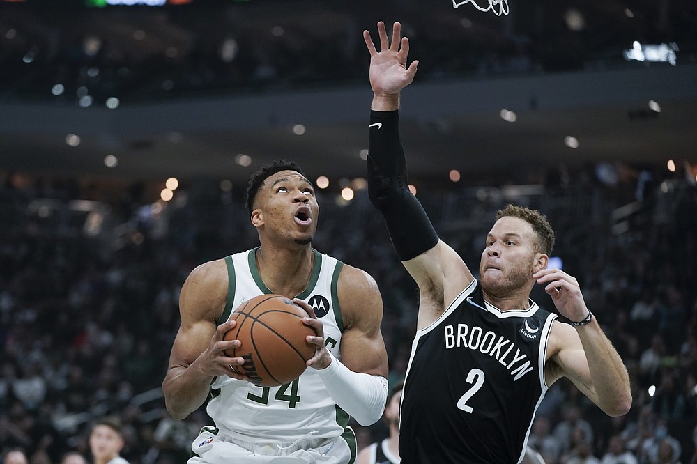 Milwaukee Bucks' Giannis Antetokounmpo (34) looks for a shot next to Brooklyn Nets' Blake Griffin (2) during the first half of an NBA basketball game Tuesday, Oct. 19, 2021, in Milwaukee. (AP Photo/Morry Gash)
