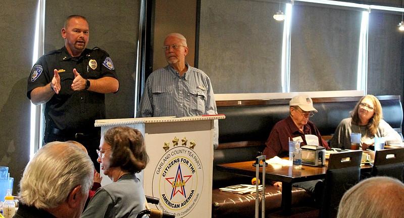 Hot Springs Police Chief Chris Chapmond, left, gestures during a speech to members of the Garland County TEA Party, including Reggie Cowan, chairman, left, during their regular meeting Wednesday at the Hibachi Sushi Buffet. - Photo by J.P. Ford of The Sentinel-Record
