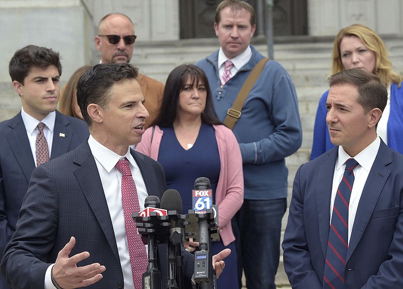 Attorneys Josh Koskoff, left front, and Chris Mattei, right front, address the media outside Connecticut Supreme Court Sept. 26, 2021, after arguments were made in the Alex Jones versus Sandy Hook case. Looking on behind Koskoff and Mattei are (left to right) attorney Matthew Blumenthal, and Sandy Hook victim family members Mark Bardin, Jennifer Hensel, Robbie Parker and Nicole Hockley. (Brad Horrigan/Hartford Courant/TNS)