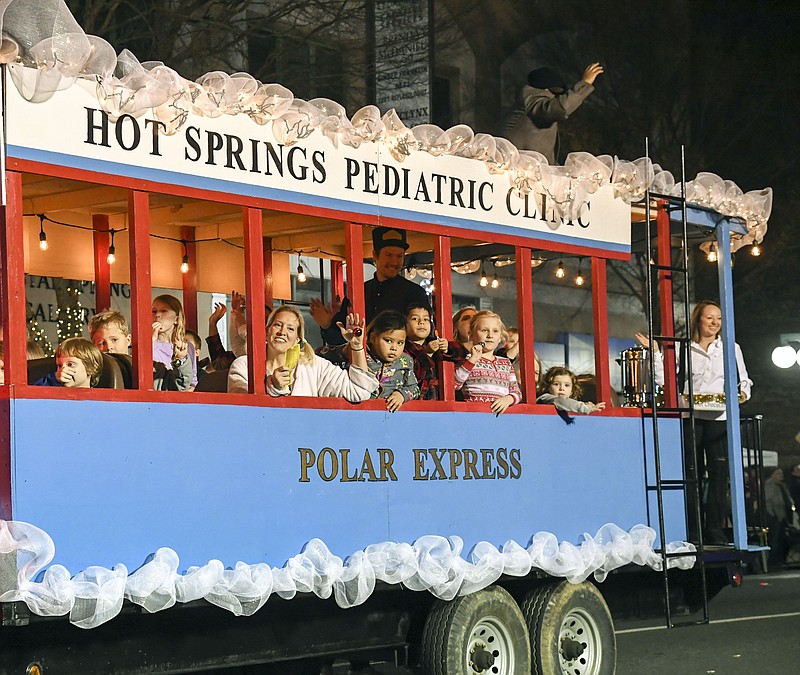 A group from Hot Springs Pediatric Clinic makes its way down Central Avenue during the Oaklawn Rotary Christmas Parade in 2019. - File photo by The Sentinel-Record